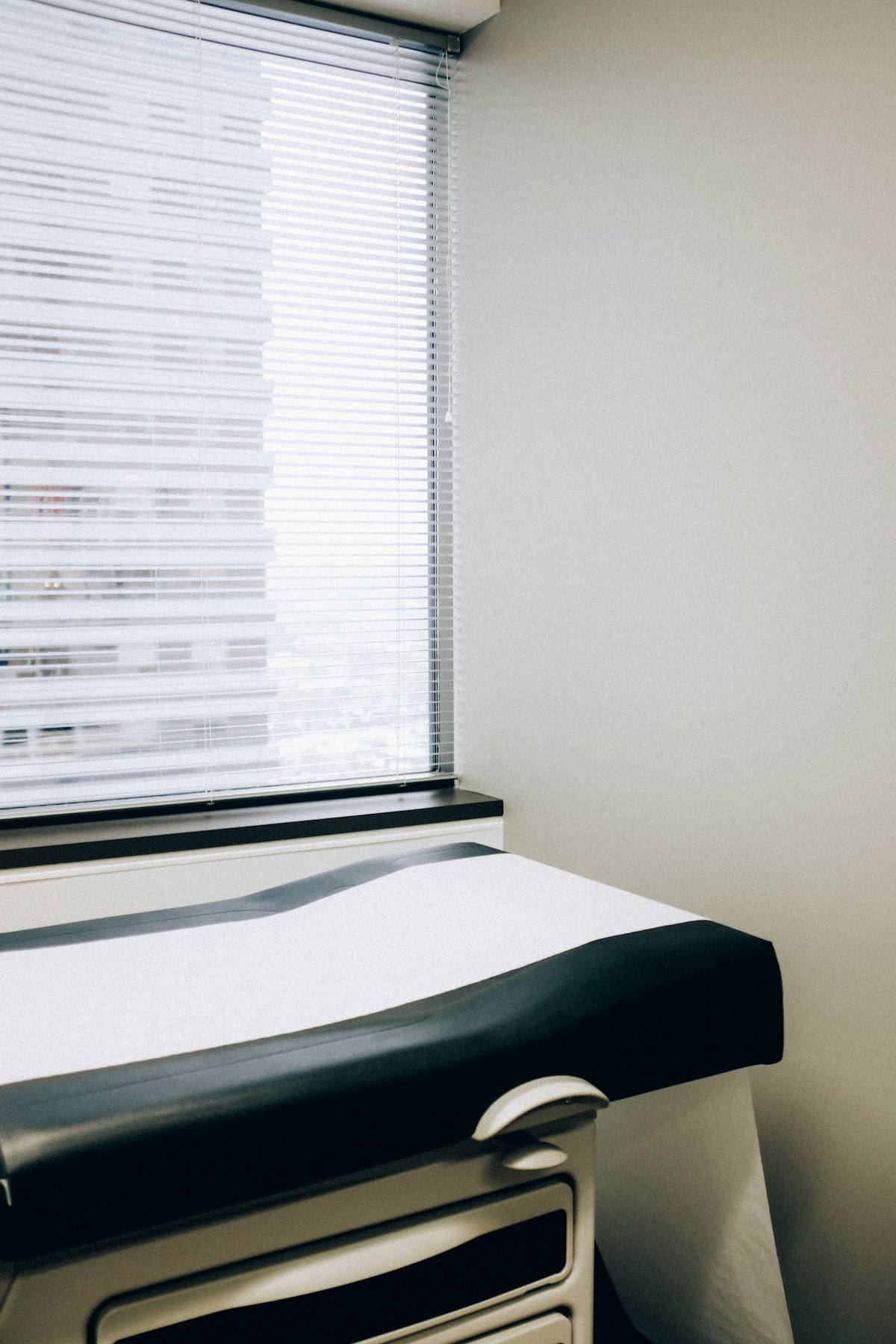 Consultation room with examination table and medical equipment