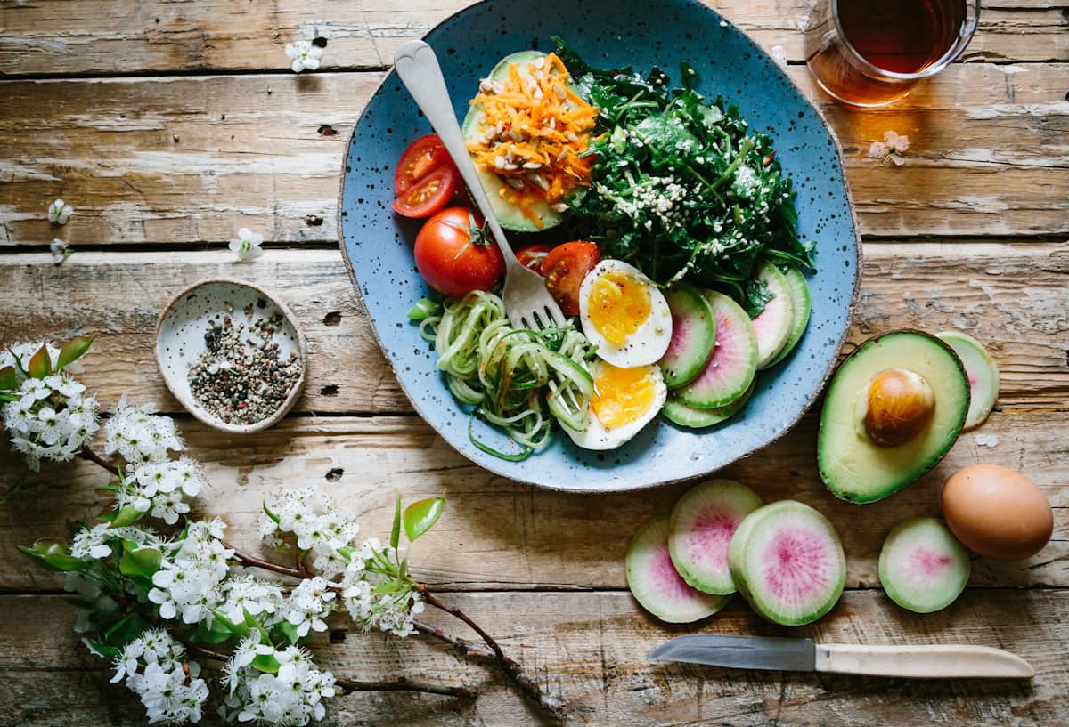 Overhead flat-lay of a balanced home-cooked meal with vegetables, grains and lean protein